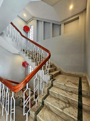 a staircase in a house with red balls on the wall at Hotel Vishal in Siliguri