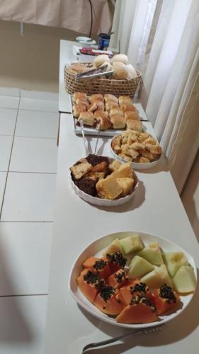 a table with three plates of food on it at Pousada do Trinta in Fernando de Noronha