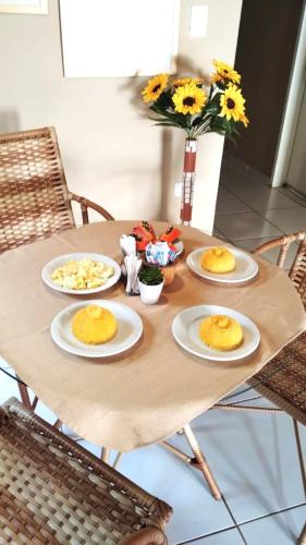 a wooden table with plates of food on it at Pousada do Trinta in Fernando de Noronha