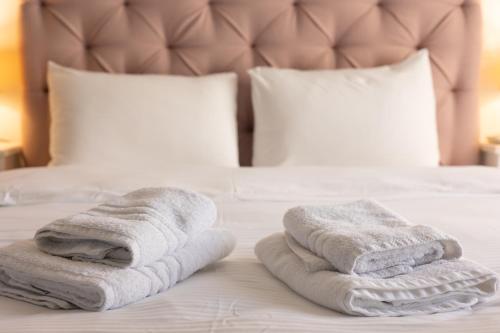 a pair of towels sitting on top of a bed at Santa Marina 6 in Ioannina