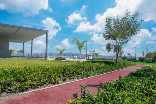 a path in a park with a playground at Casa de Relax con Alberca y bellas Amenidades in Xochitepec