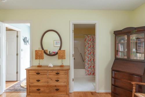 a room with a dresser and a mirror and a closet at Quiet Dataw Island Villa with Water Views in Dataw Island