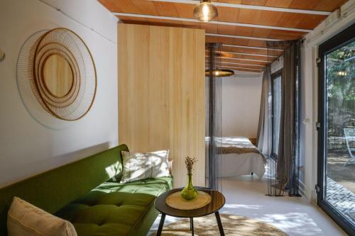 a living room with a green couch and a table at antiguo gallinero in Collado-Villalba