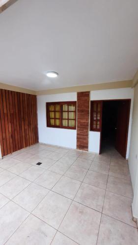an empty room with a large tile floor and windows at Dúplex 6 personas centro in San Ignacio