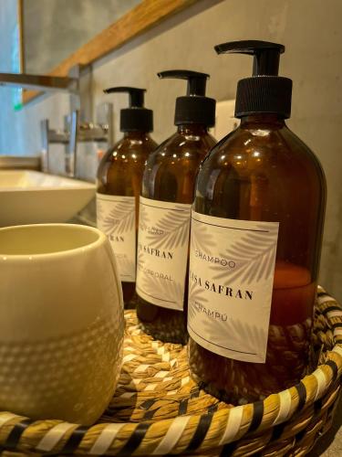 three bottles of soap in a basket on a counter at Casa Safran Vichayito in Los Órganos