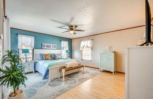 a bedroom with a bed and a ceiling fan at Waterfront Florida Escape with Deck and Private Dock! in Hernando Beach
