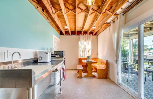 a kitchen with a large window and a table at Waterfront Florida Escape with Deck and Private Dock! in Hernando Beach