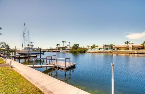 a dock with a boat in the water at Waterfront Florida Escape with Deck and Private Dock! in Hernando Beach