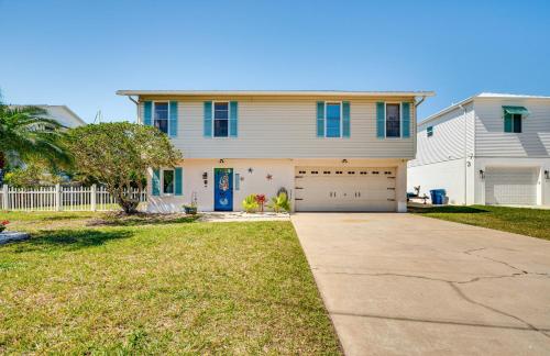 a white house with a blue door and a driveway at Waterfront Florida Escape with Deck and Private Dock! in Hernando Beach