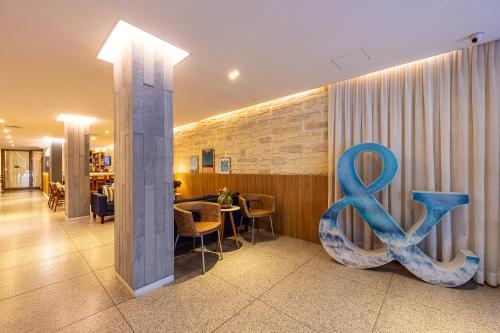 a restaurant with a large blue symbol on the wall at B&B HOTEL Rio Copacabana Posto 5 in Rio de Janeiro