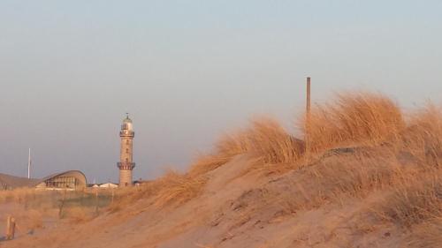 a lighthouse on the side of a sand hill at Appartement Romantik in Warnemünde