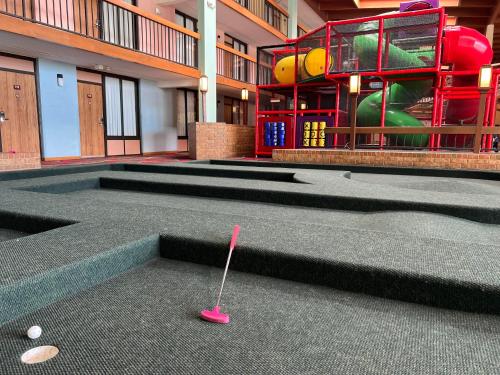 a golf club in the middle of a building at MCM Grande FunDome Odessa in Odessa