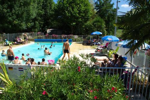 un groupe de personnes dans une piscine dans l'établissement Camping LePigeonnier à Miers près du gouffre de Padirac, à Miers