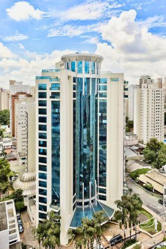 a tall building in a city with buildings at Hotel São Paulo - Premium Experience - Ibirapuera - Moema District in Sao Paulo