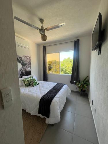a bedroom with a large bed and a window at Casa Monstera Bahia in Naranjo