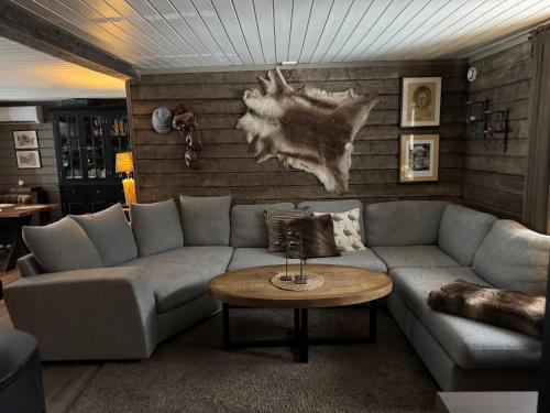 a living room with a couch and a table at Sälen Osanden in Sälen