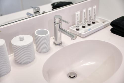 a bathroom counter with a sink and a mirror at Ultra Luxury Apt - Panoramic NYC View - Minutes to City in Hoboken