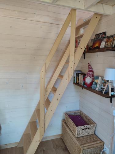 a wooden staircase in a room with a wall at tiny house Cantal in Marcolès