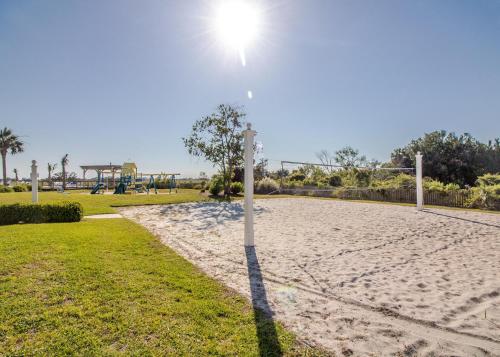 a volley ball net on a sandy volleyball court at The Oyster's Pearl - Wonderful Views in Harbour Key in Fripp Island
