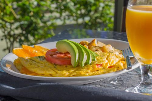 a plate of food on a table with a glass of orange juice at Holiday Inn Carlsbad/San Diego by IHG in Carlsbad