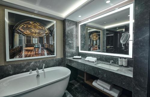 利马InterContinental Hotels Real Lima Miraflores by IHG的带浴缸和大镜子的浴室