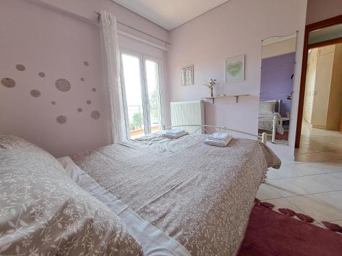 a bedroom with a bed and a large window at Up on the hill in Nafpaktos