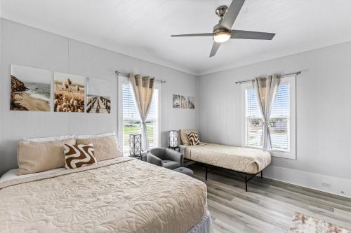 a bedroom with a bed and a ceiling fan at Ocean Paradise 5BR Beach Escape Hot Tub Game Room and Firepit in Gilchrist
