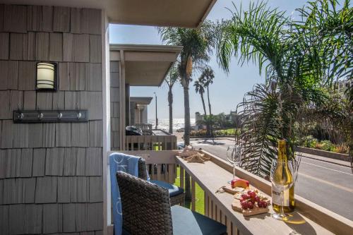 a balcony with a table with a bottle of wine at Walk to the Beach Balcony Sunset Ocean Views in Oceanside
