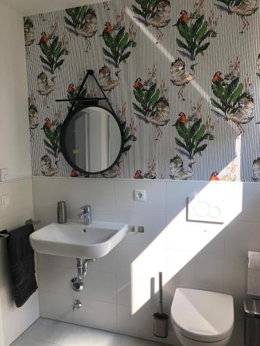 a bathroom with a sink and a mirror at Apartment im Grünen mit Stil in Mitterfels