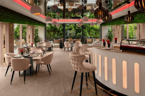 a restaurant with chairs and tables and a bar at Delta Hotels by Marriott Antalya Lara - Adult Only 18 Plus in Antalya