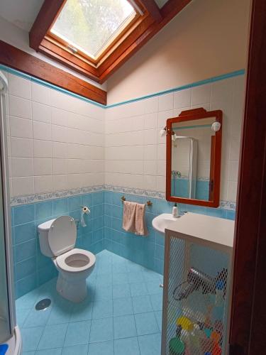 a bathroom with a toilet and a sink and a window at The living mountain - SAJA - CASONA RURAL in Saja