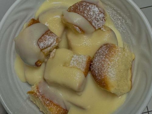 a plate of pastry with powdered sugar on it at Penzion Čítkův Mlýn in Šluknov