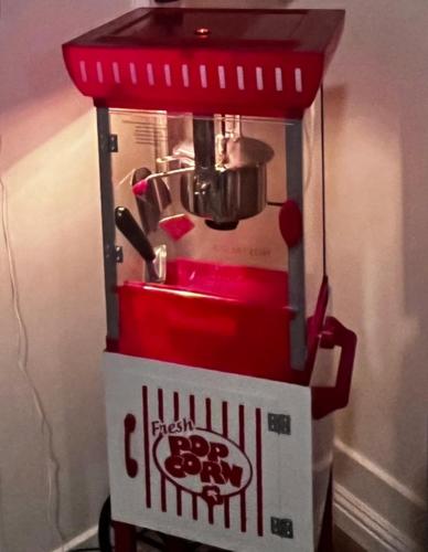 a red and white drink dispenser sitting on a table at Reno MidTown Movie House in Reno