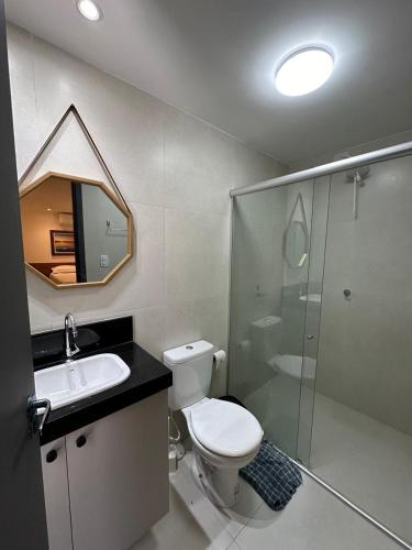 a bathroom with a toilet and a sink and a shower at Bessa Flat Conforto à 180m do Mar - Storey Luxor in João Pessoa