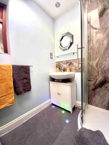 a bathroom with a sink and a shower at The Hanham Retreat in Bristol