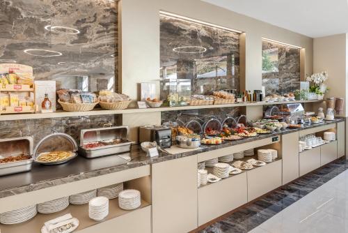 a buffet line with a variety of food on display at Art Hotel Navigli in Milan