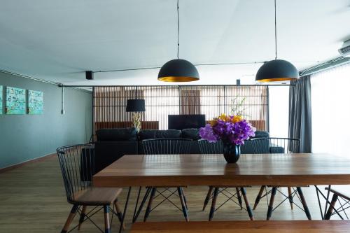 una sala de estar con una mesa con flores. en Nord Studio en Chiang Mai