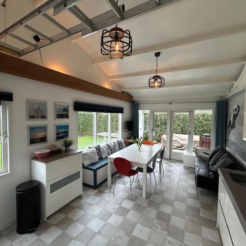 a living room with a table and a couch at Nice chalet near Reeuwijkse plassen in Reeuwijk