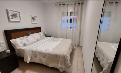 En eller flere senge i et værelse på Apartamento Tintín Moraira