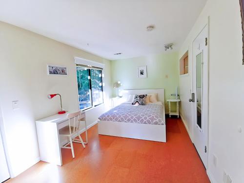 a bedroom with a bed and a desk at POWER ON - City Oasis in Issaquah