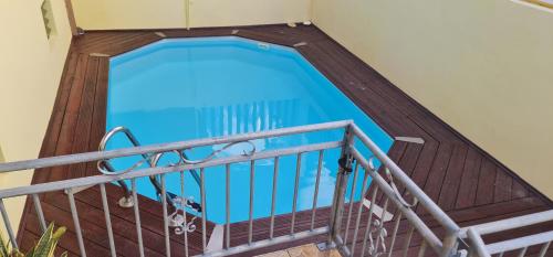 a swimming pool on the balcony of a house at Vue mer et montagne in Vieux-Habitants