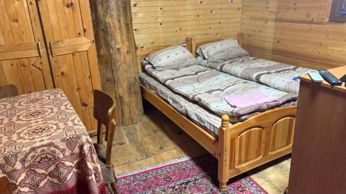 a room with two beds in a wooden cabin at Tree House in Sofia