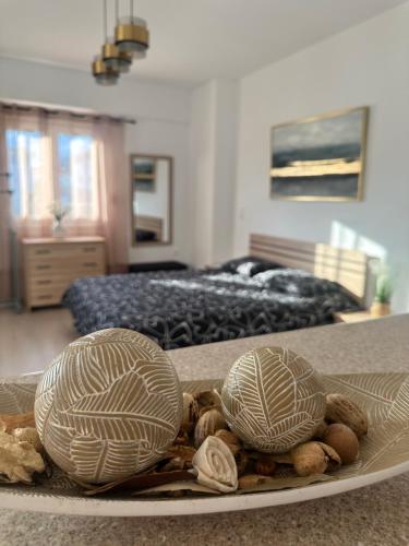 two shells on a plate on a table in a bedroom at Parthenis appartments in Pythagoreio