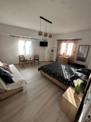 a bedroom with a large bed and a living room at Parthenis appartments in Pythagoreio