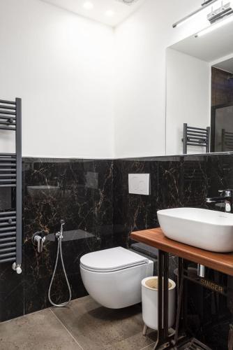a bathroom with a white toilet and a sink at Corte dell'Albero in Florence