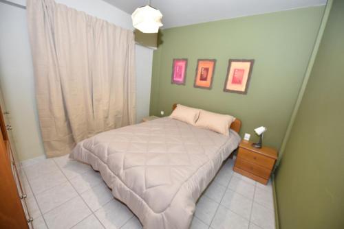 a small bedroom with a bed and a window at Sweet Home in Glykórrizon
