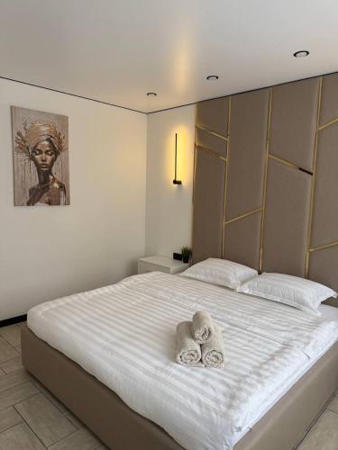 a bedroom with a bed with towels on it at Торайгырова 89 in Pavlodar