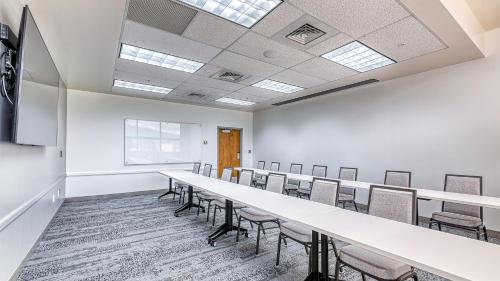 a conference room with a long table and chairs at University Inn in Logan
