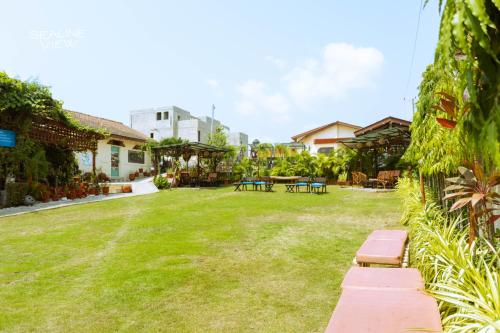 a yard with benches and tables in a yard at Sealine View Hospitality Centre in Oblogo