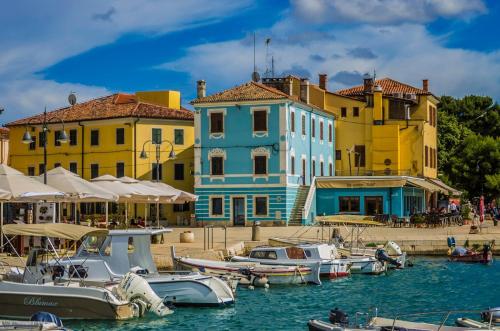 a group of boats docked in a harbor with buildings at Apartman Nonno Božo 2 in Fažana